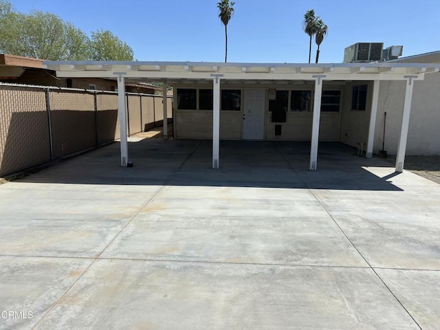 391 N 9th St, Blythe, CA 92225 - back of property with central AC, fence, a carport, and concrete driveway