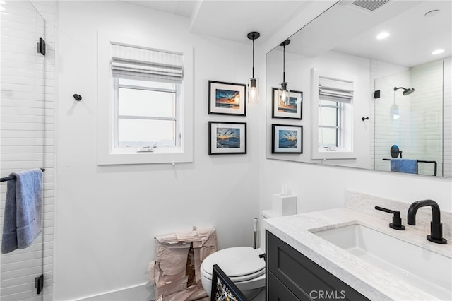 bathroom with a stall shower, vanity, toilet, visible vents, and recessed lighting