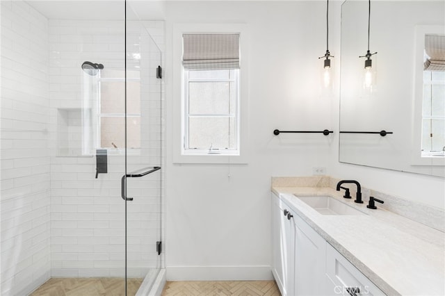 full bathroom featuring baseboards, vanity, and a shower stall