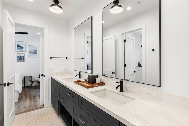ensuite bathroom featuring ensuite bath, a sink, double vanity, and a stall shower