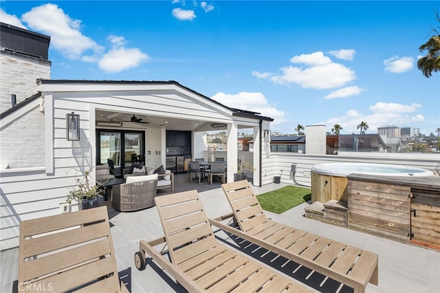 view of patio / terrace with an outdoor hangout area, a hot tub, and outdoor dining area