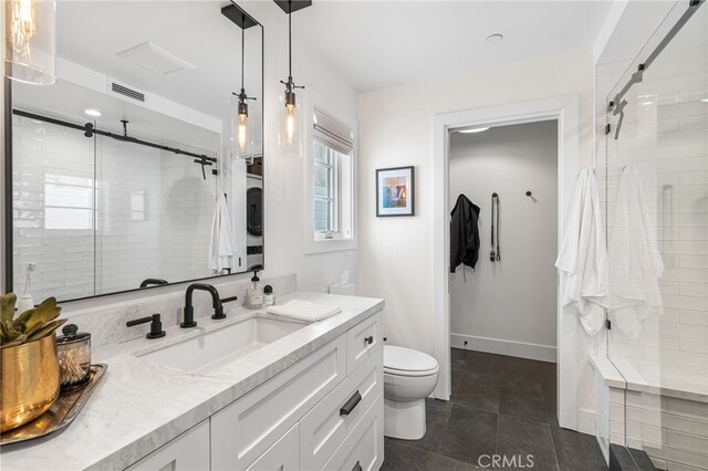 bathroom featuring tile patterned flooring, visible vents, toilet, vanity, and a stall shower