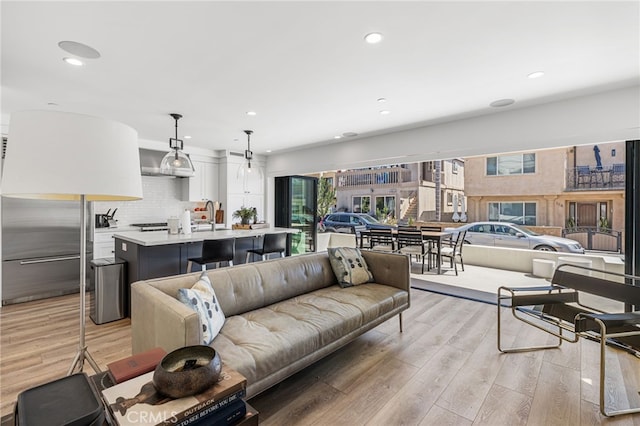 living room with recessed lighting and light wood-style floors