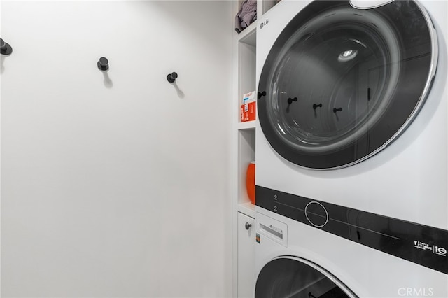 laundry area with stacked washer / dryer and laundry area