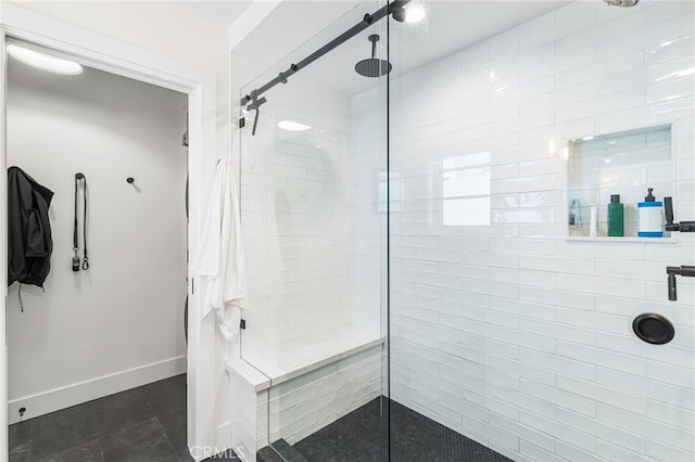full bath with baseboards and tiled shower