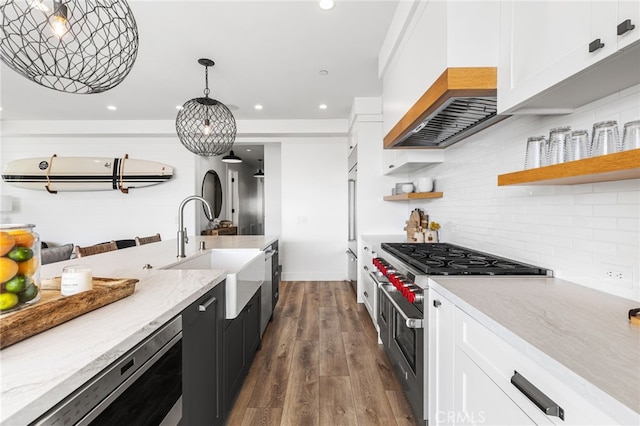 kitchen with white cabinetry, a sink, high end appliances, and recessed lighting