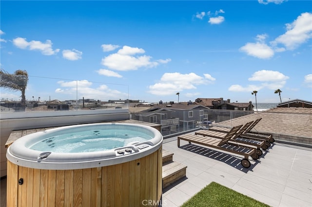 view of swimming pool with a hot tub