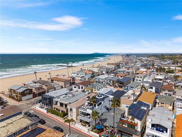 drone / aerial view with a beach view and a water view