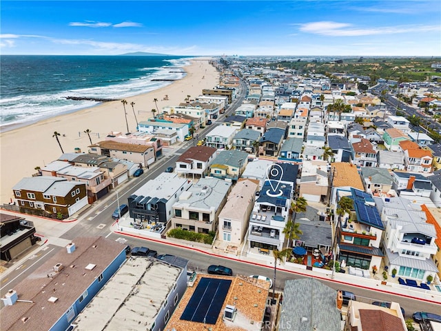 birds eye view of property featuring a beach view, a residential view, and a water view