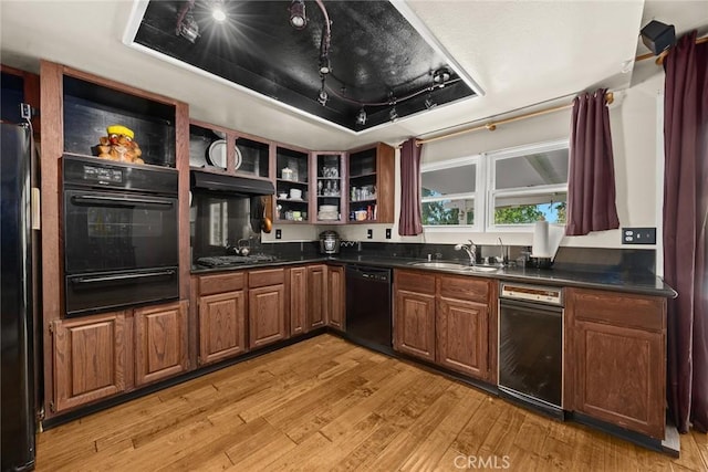 13771 De Garmo Ave, Rancho Cascades, CA 91342 - kitchen with black appliances, a warming drawer, a sink, light wood finished floors, and dark countertops