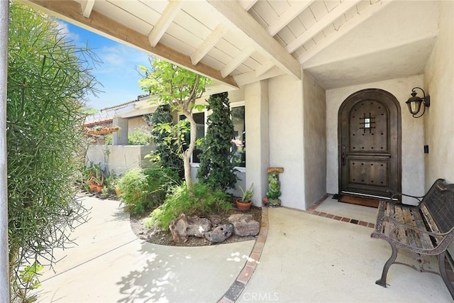 13771 De Garmo Ave, Rancho Cascades, CA 91342 - doorway to property featuring stucco siding and fence