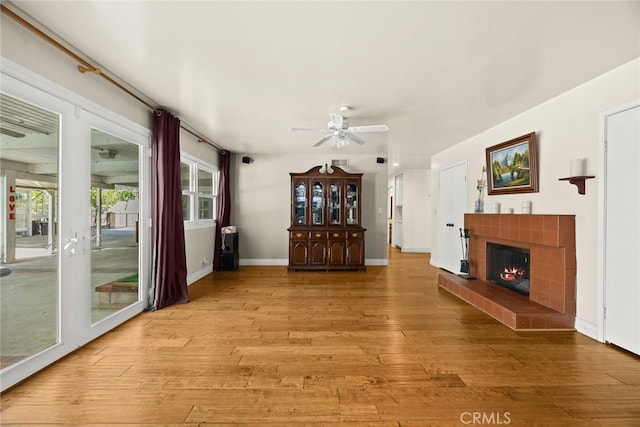 13771 De Garmo Ave, Rancho Cascades, CA 91342 - unfurnished living room featuring ceiling fan, light wood-style flooring, a tile fireplace, and baseboards