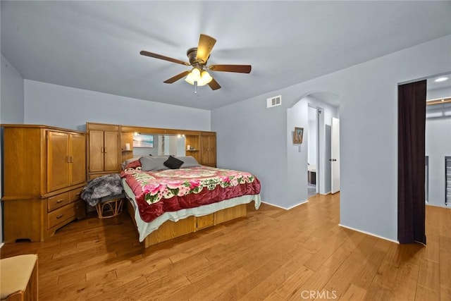 13771 De Garmo Ave, Rancho Cascades, CA 91342 - bedroom featuring light wood-style flooring, arched walkways, and ceiling fan