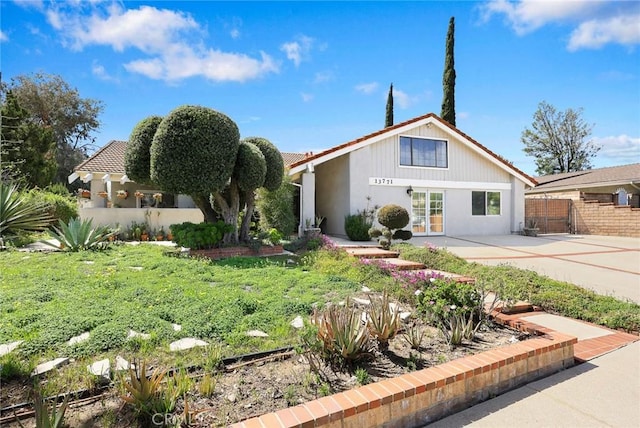 13771 De Garmo Ave, Rancho Cascades, CA 91342 - view of front of home featuring fence, a patio, and french doors