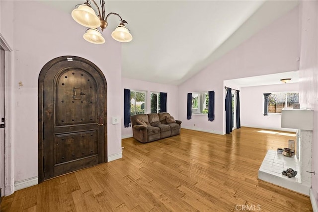 13771 De Garmo Ave, Rancho Cascades, CA 91342 - foyer with high vaulted ceiling, wood finished floors, baseboards, and arched walkways