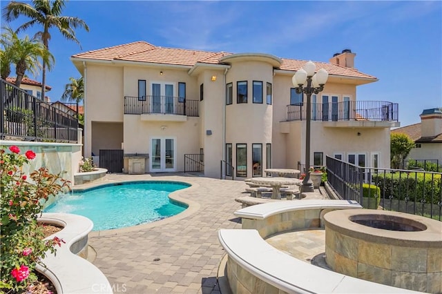 8113 Newcastle Dr, Whittier, CA 90605 - view of swimming pool featuring a fire pit, a fenced in pool, a patio area, fence, and french doors