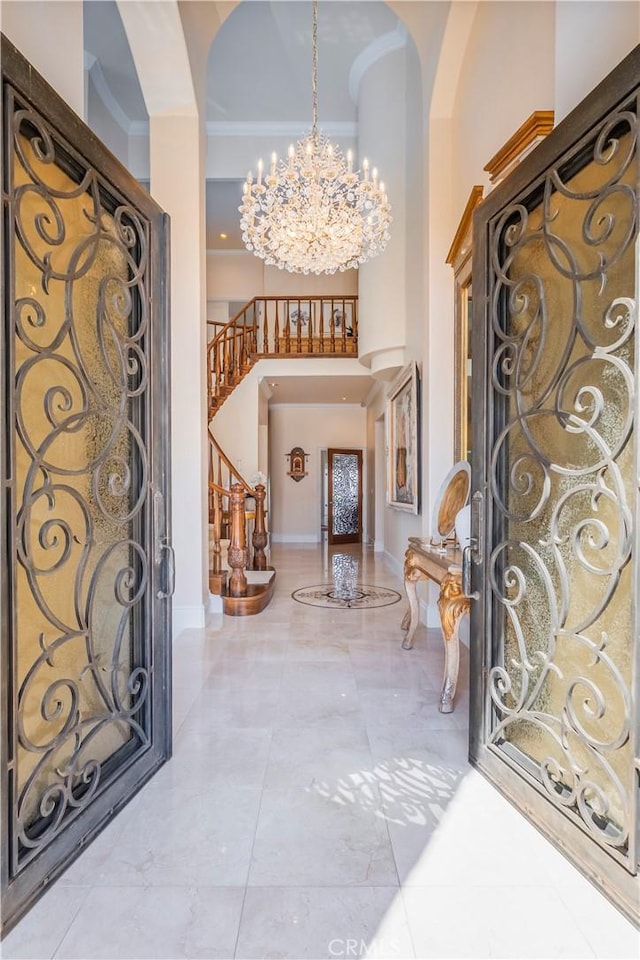 8113 Newcastle Dr, Whittier, CA 90605 - entryway with a chandelier, a high ceiling, stairs, and arched walkways