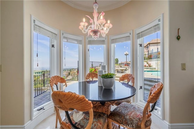 8113 Newcastle Dr, Whittier, CA 90605 - dining area featuring a chandelier, crown molding, and baseboards