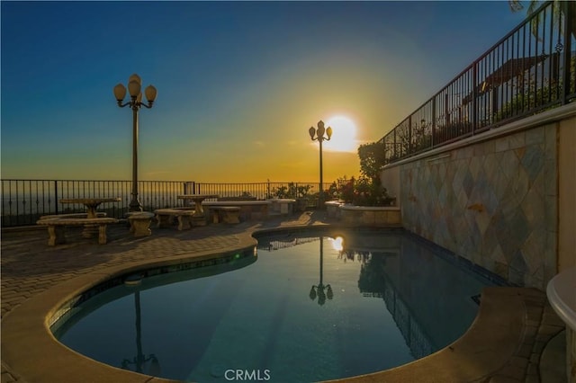 8113 Newcastle Dr, Whittier, CA 90605 - pool at dusk with fence, a fenced in pool, and a patio area