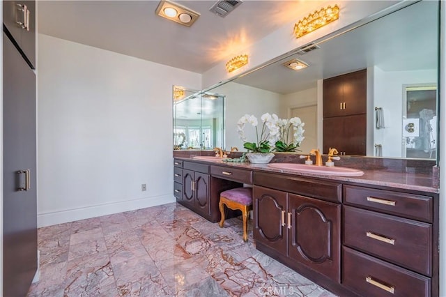 8113 Newcastle Dr, Whittier, CA 90605 - bathroom featuring double vanity, visible vents, baseboards, and a sink
