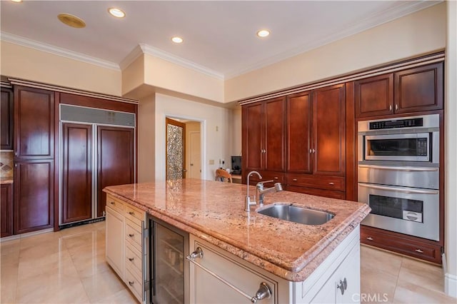 8113 Newcastle Dr, Whittier, CA 90605 - kitchen featuring a sink, built in appliances, beverage cooler, light tile patterned flooring, and an island with sink