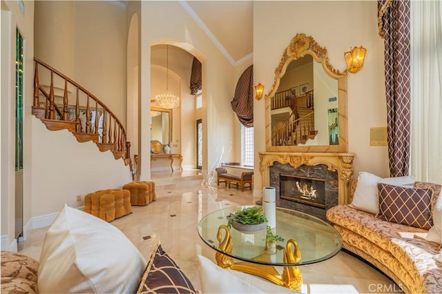 8113 Newcastle Dr, Whittier, CA 90605 - sitting room with arched walkways, a high end fireplace, baseboards, stairway, and crown molding
