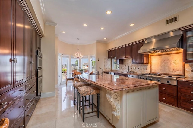 8113 Newcastle Dr, Whittier, CA 90605 - kitchen featuring a sink, stainless steel appliances, tasteful backsplash, wall chimney exhaust hood, and visible vents