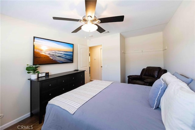 bedroom with dark wood-style floors, baseboards, ceiling fan, and visible vents