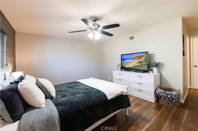 bedroom featuring visible vents, ceiling fan, and dark wood-style flooring