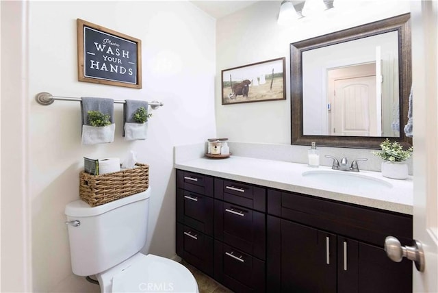 half bath featuring toilet and vanity