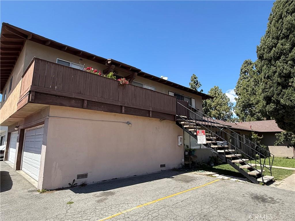 2602 W Aurora St Unit 4, Santa Ana, CA 92704 - view of home's exterior with stucco siding, stairs, and crawl space