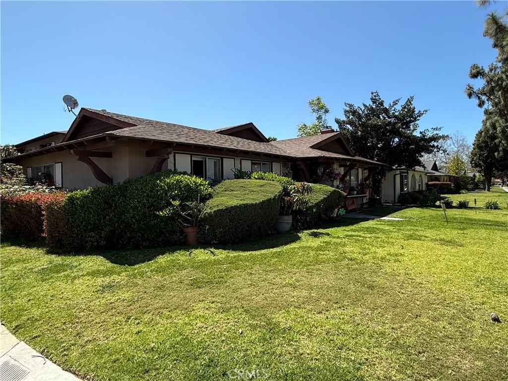 2602 W Aurora St Unit 4, Santa Ana, CA 92704 - view of property exterior featuring stucco siding and a yard
