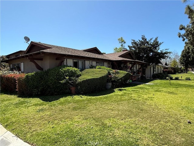 2602 W Aurora St Unit 4, Santa Ana, CA 92704 - view of property exterior featuring stucco siding and a yard