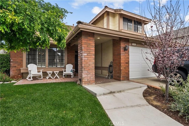 view of front of house with a garage, a front yard, and brick siding