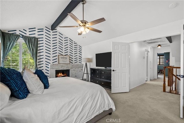 bedroom featuring ceiling fan, a fireplace, lofted ceiling with beams, and carpet floors