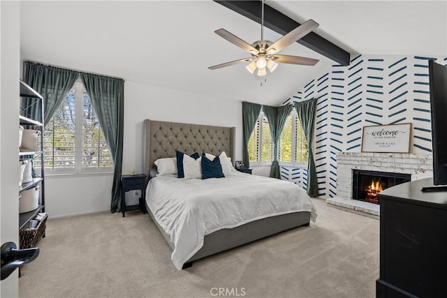 carpeted bedroom featuring ceiling fan, a fireplace, baseboards, and vaulted ceiling with beams