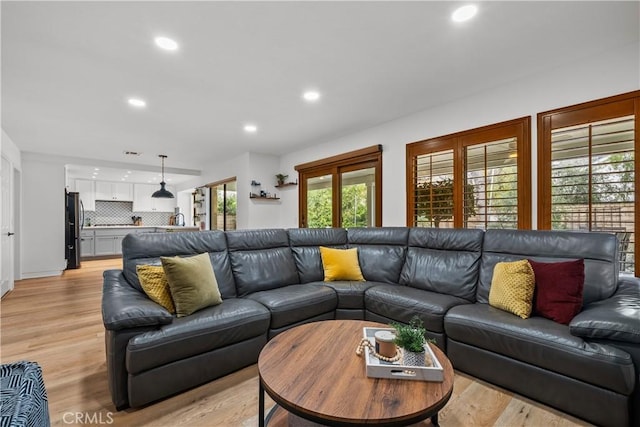 living room with recessed lighting and light wood-style flooring