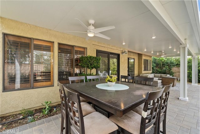 view of patio / terrace with outdoor dining space, an outdoor living space, and ceiling fan