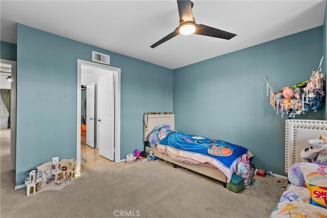 bedroom with carpet, visible vents, baseboards, and ceiling fan
