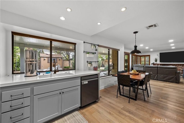 kitchen with stainless steel dishwasher, recessed lighting, visible vents, and light wood-type flooring