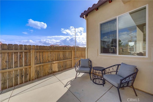 view of patio featuring fence