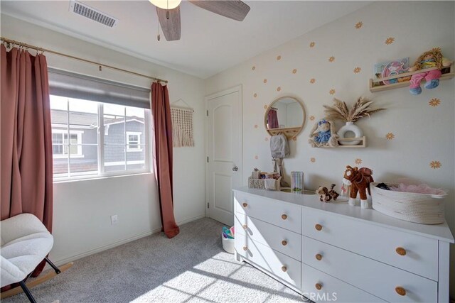 bedroom featuring light colored carpet, baseboards, a ceiling fan, and visible vents