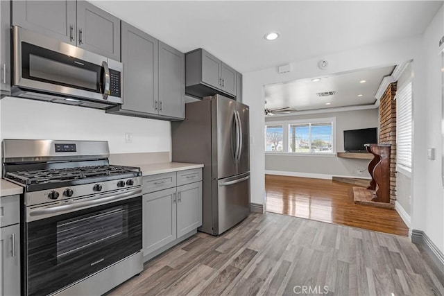 7451 Western Ave, Buena Park, CA 90620 - kitchen with gray cabinets, stainless steel appliances, light countertops, light wood finished floors, and baseboards