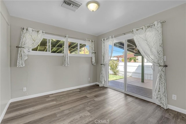 7451 Western Ave, Buena Park, CA 90620 - unfurnished room with wood finished floors, visible vents, and baseboards