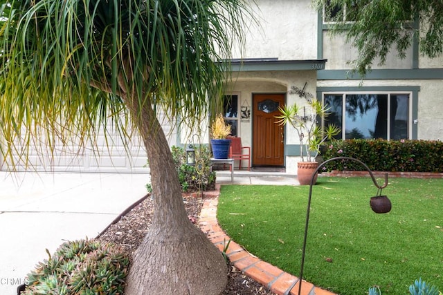 3301 Regatta Pl, Oxnard, CA 93035 - property entrance with covered porch, stucco siding, and a lawn