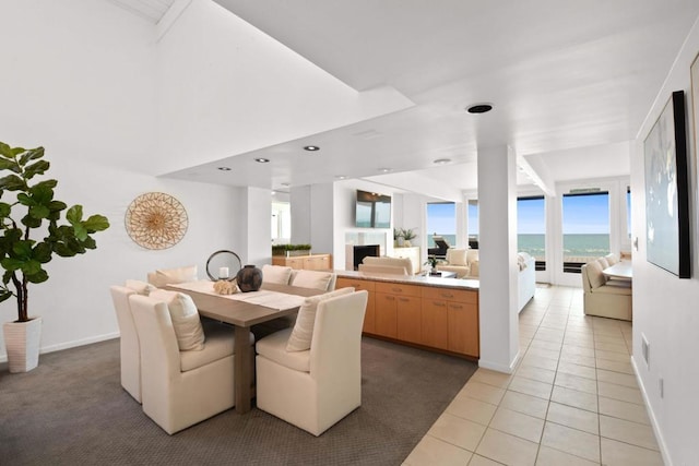 35321 Beach Rd, Dana Point, CA 92624 - dining area with a fireplace, baseboards, and light tile patterned floors