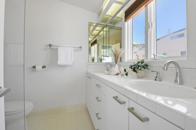 35321 Beach Rd, Dana Point, CA 92624 - full bath with baseboards, a sink, double vanity, and toilet