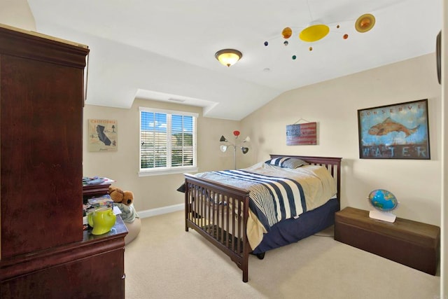 carpeted bedroom featuring vaulted ceiling and baseboards