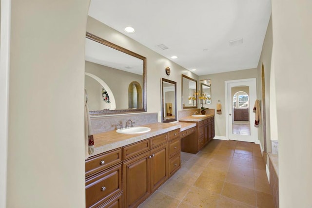bathroom featuring backsplash, vanity, visible vents, and recessed lighting