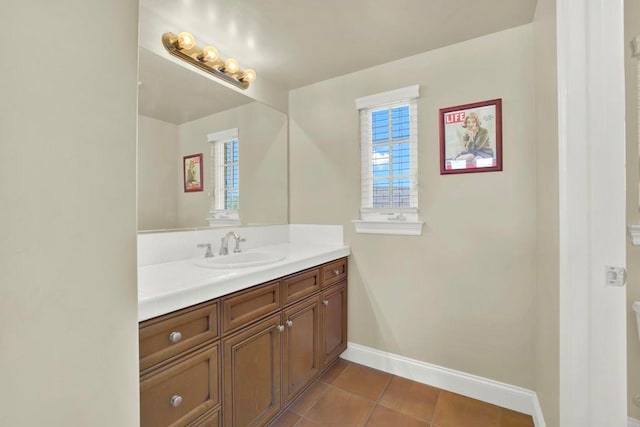 bathroom with baseboards, vanity, and tile patterned floors